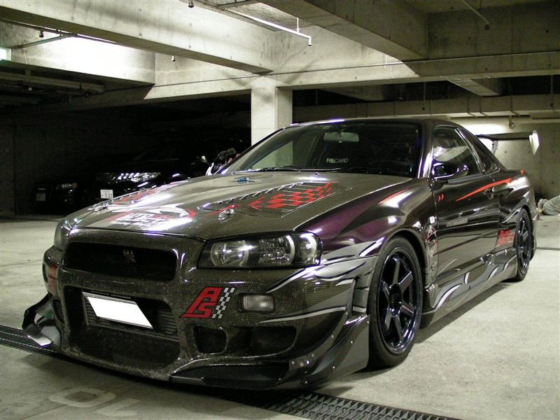This purple Nissan Skyline R34 GTR features the full replacement bumper as